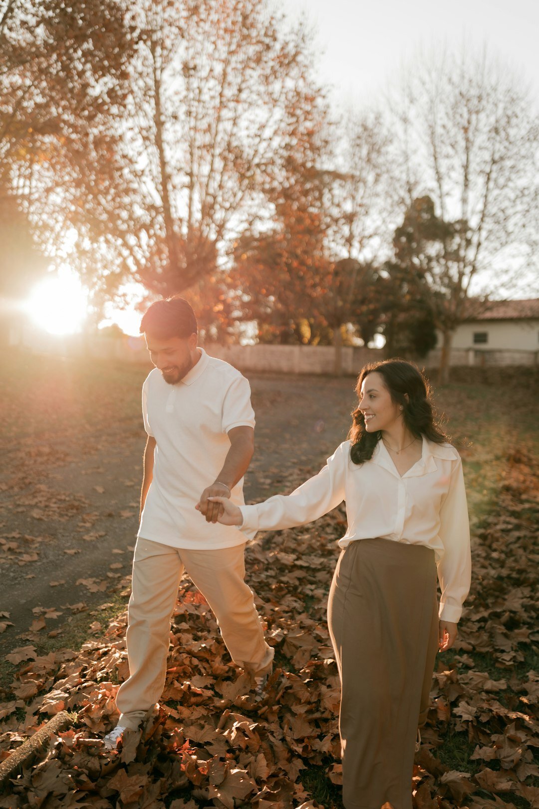 couple walking in park at sunset